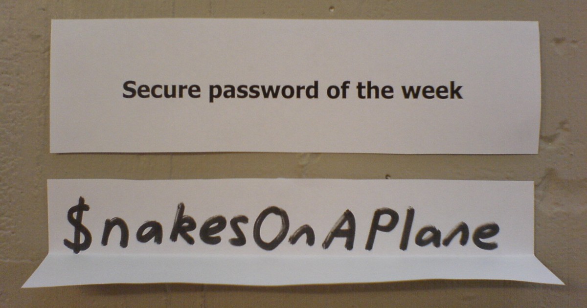 Two paper signs on a wall. Top reads 'Secure password of the week'; bottom shows a playful password: '$nakesOnAPlane'.